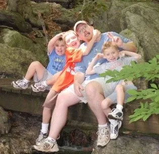 Christopher with his three sons on a hike