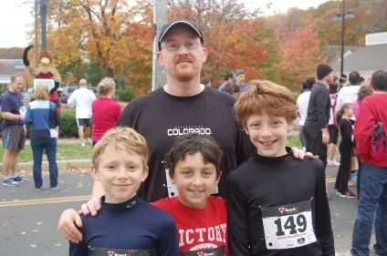 Christopher with his three sons at a road race